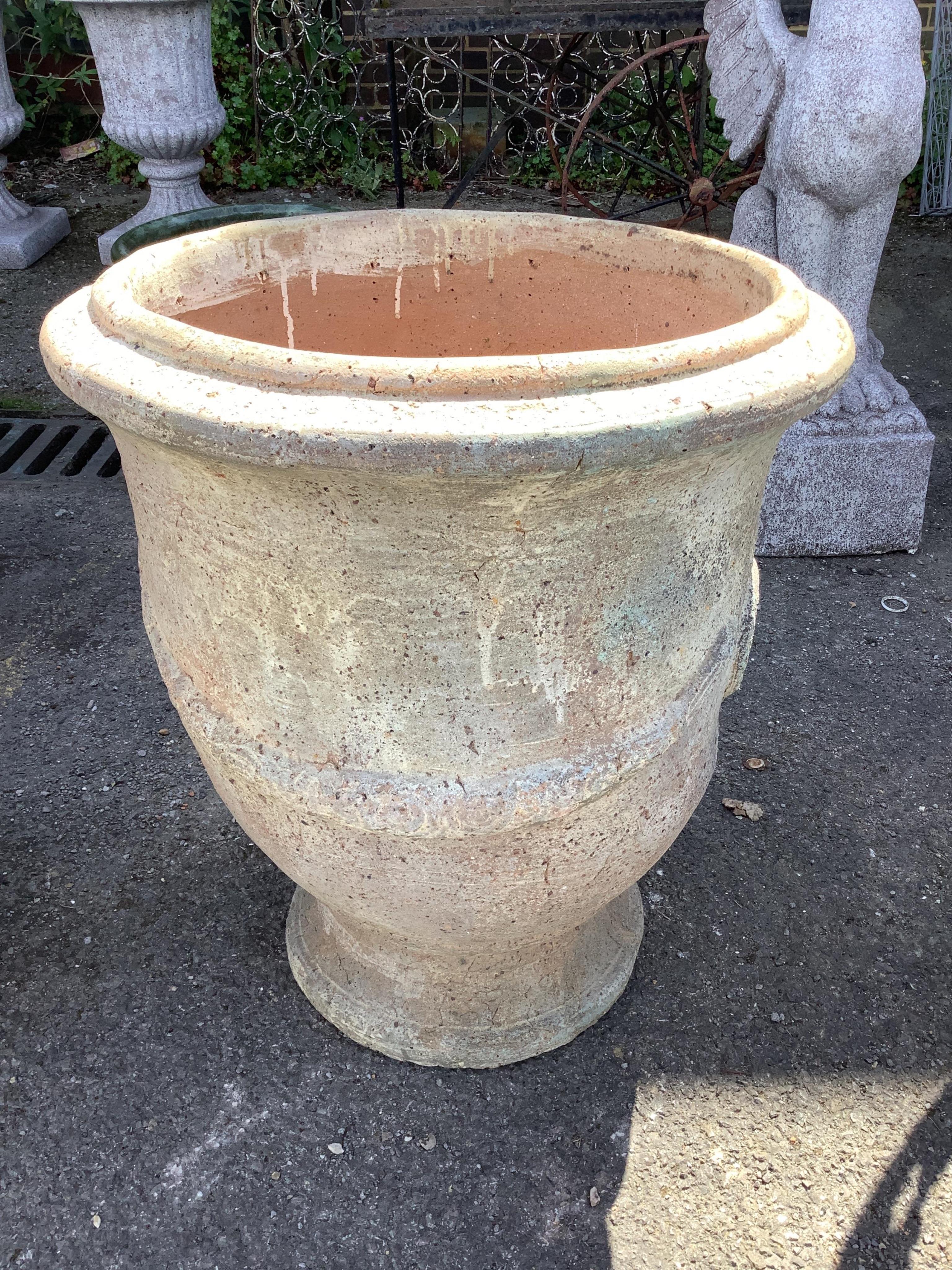 A pair of large circular earthenware garden planters, diameter 61cm, height 68cm